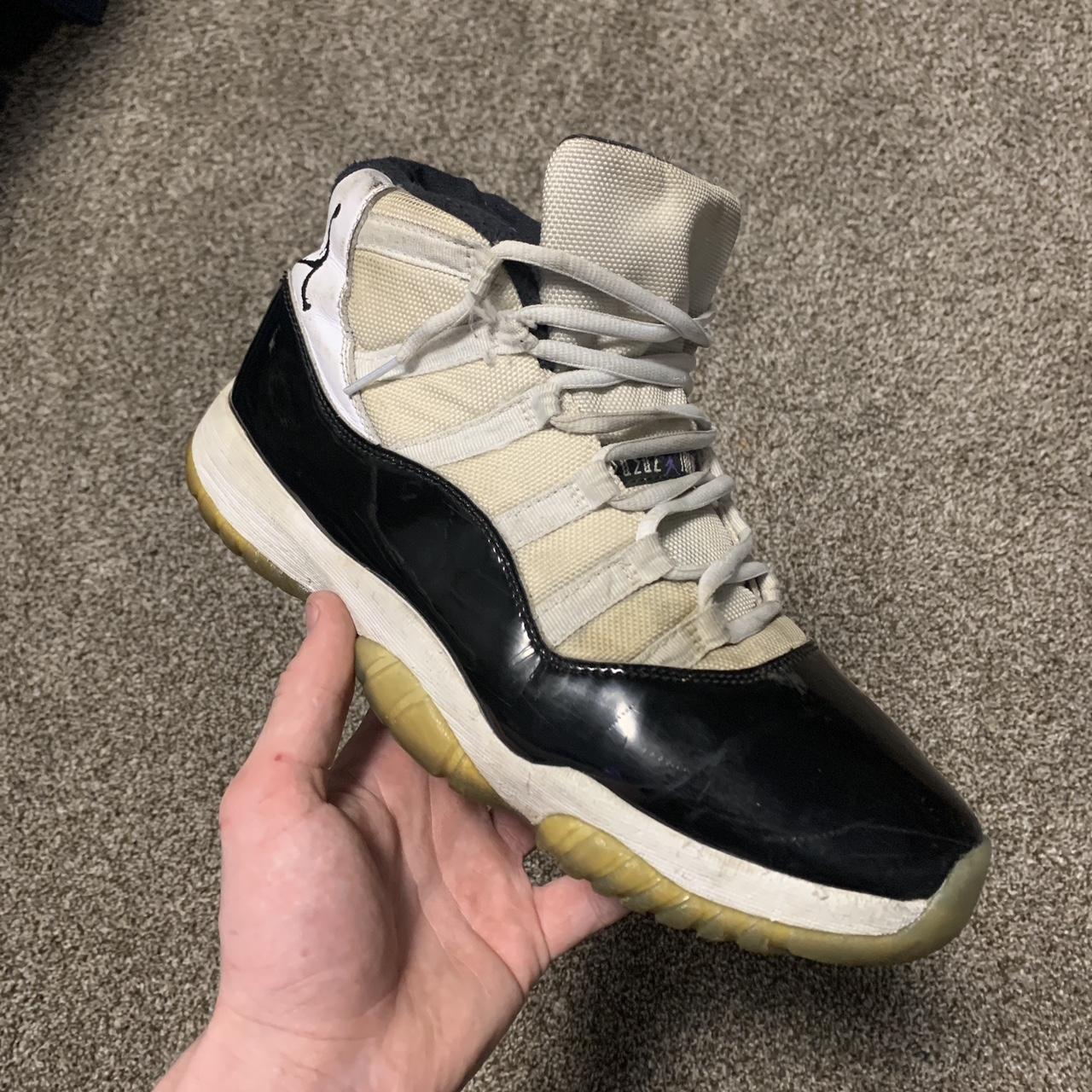 White and black Jordan 11 s with yellowed souls and