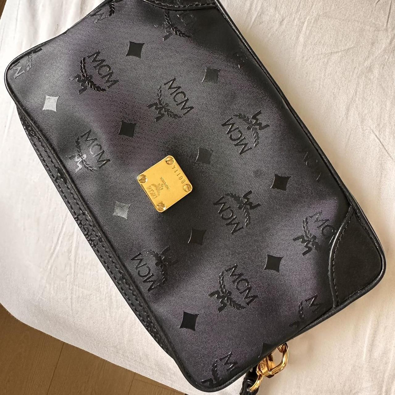 Preloved MCM pouch wristlet in black PVC gold. Depop