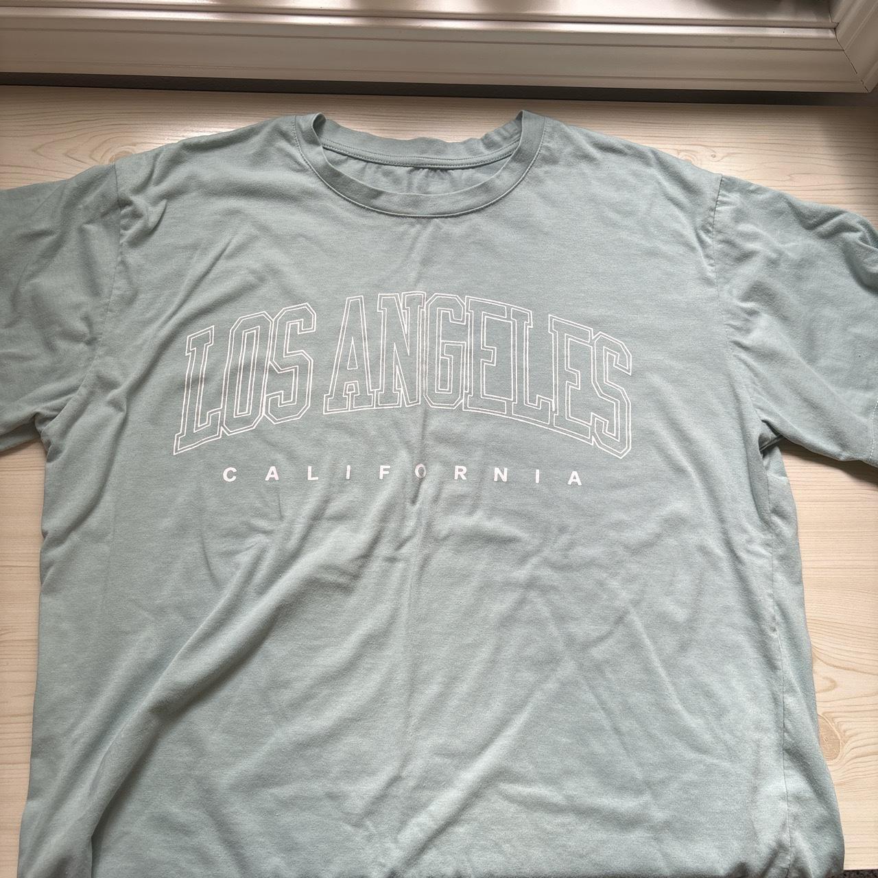 L baby blue Los Angeles t-shirt not sure what the... - Depop