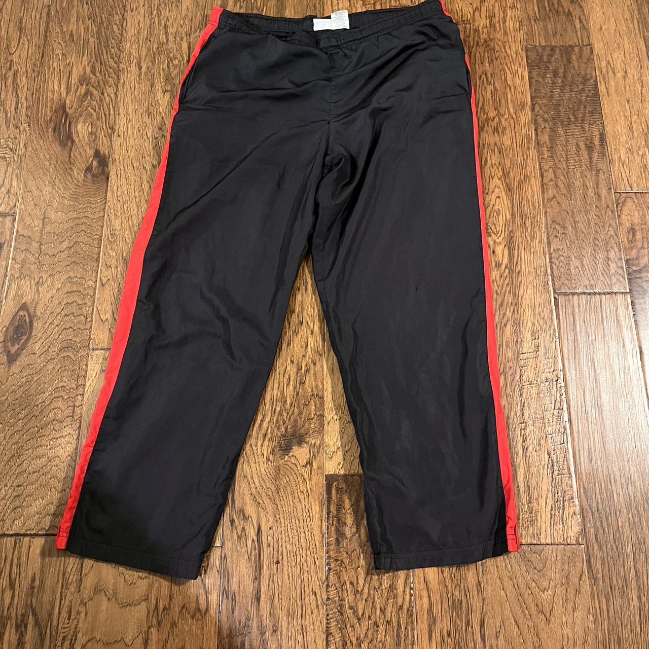 Baggy black track pants with red line on the side... - Depop