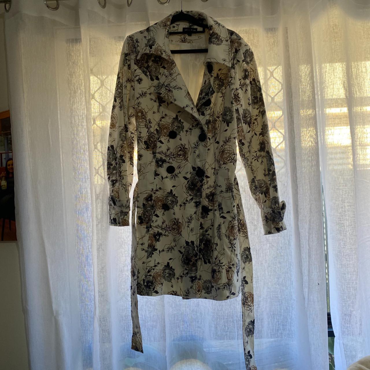 White coat with black roses with gold throughout.... Depop