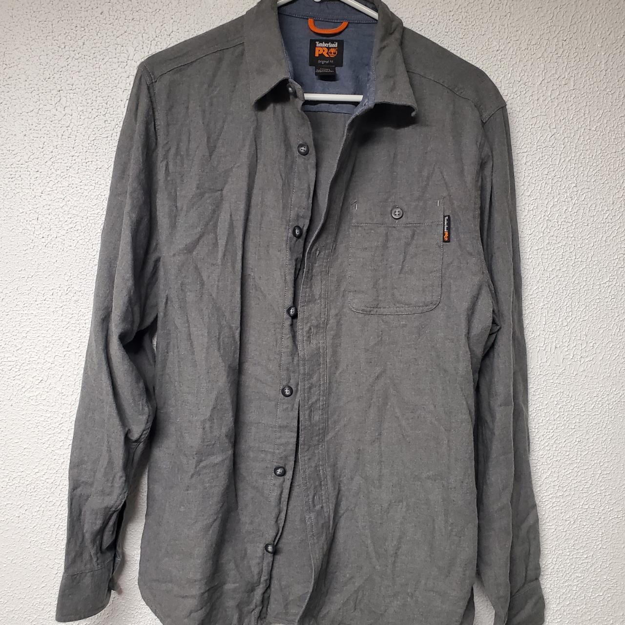 This Timberland shirt for men features a solid gray... - Depop