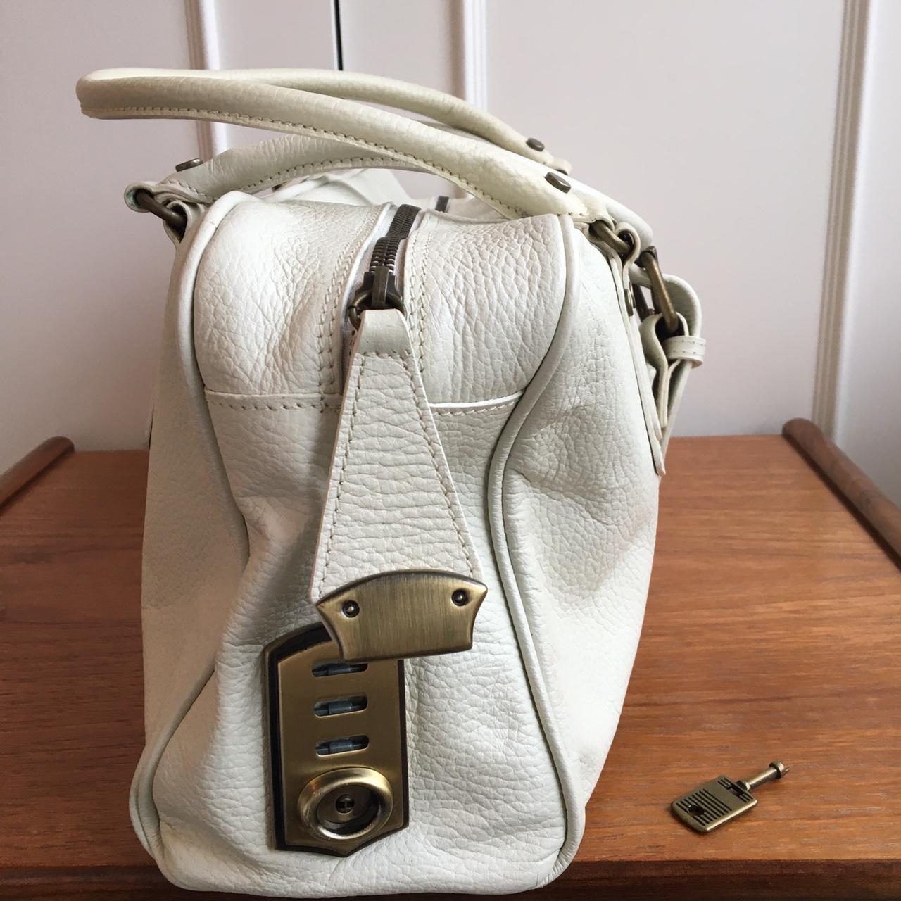 Off white leather handbag. Lockable, key included.... Depop