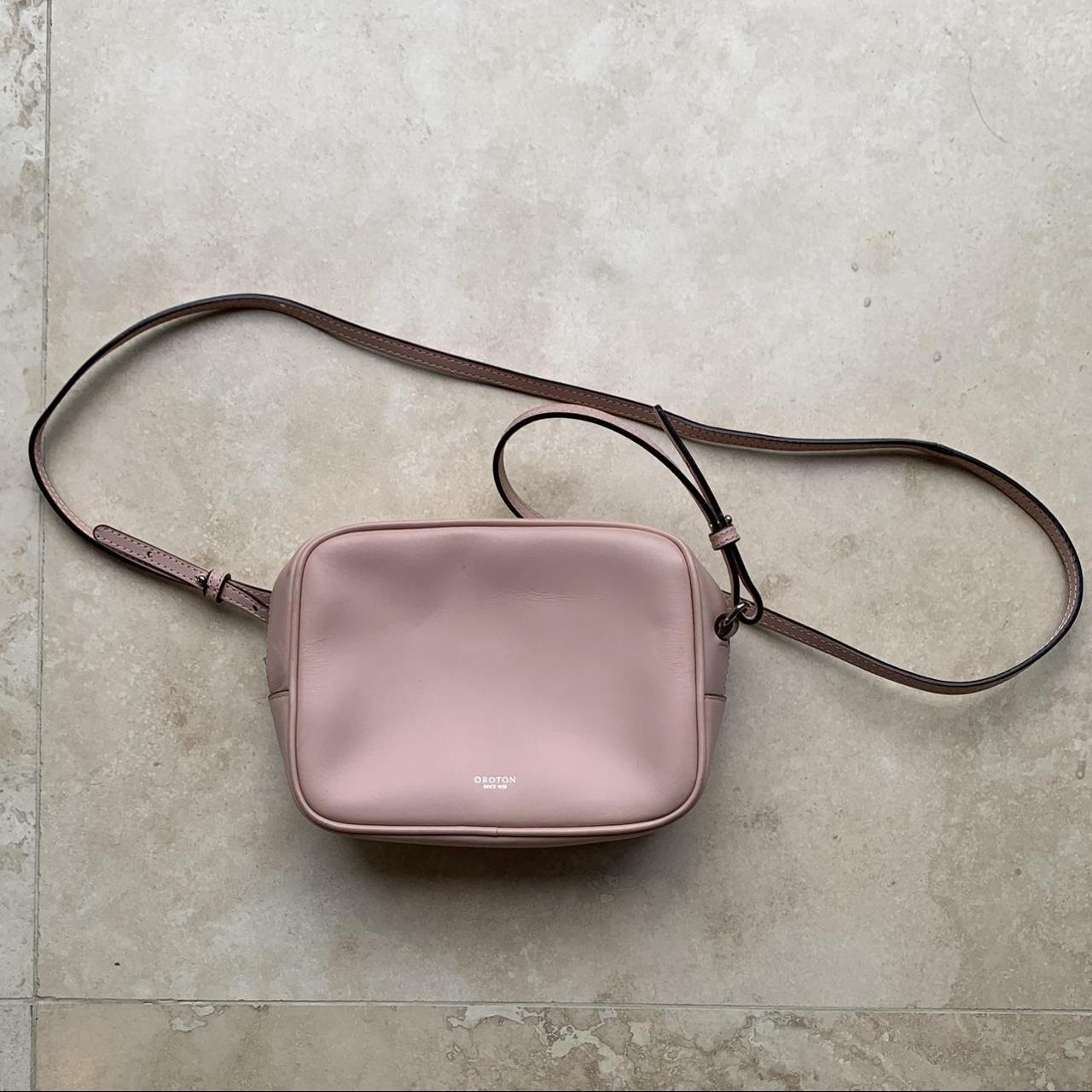 Pink Oroton crossbody bag with silver detailing. A