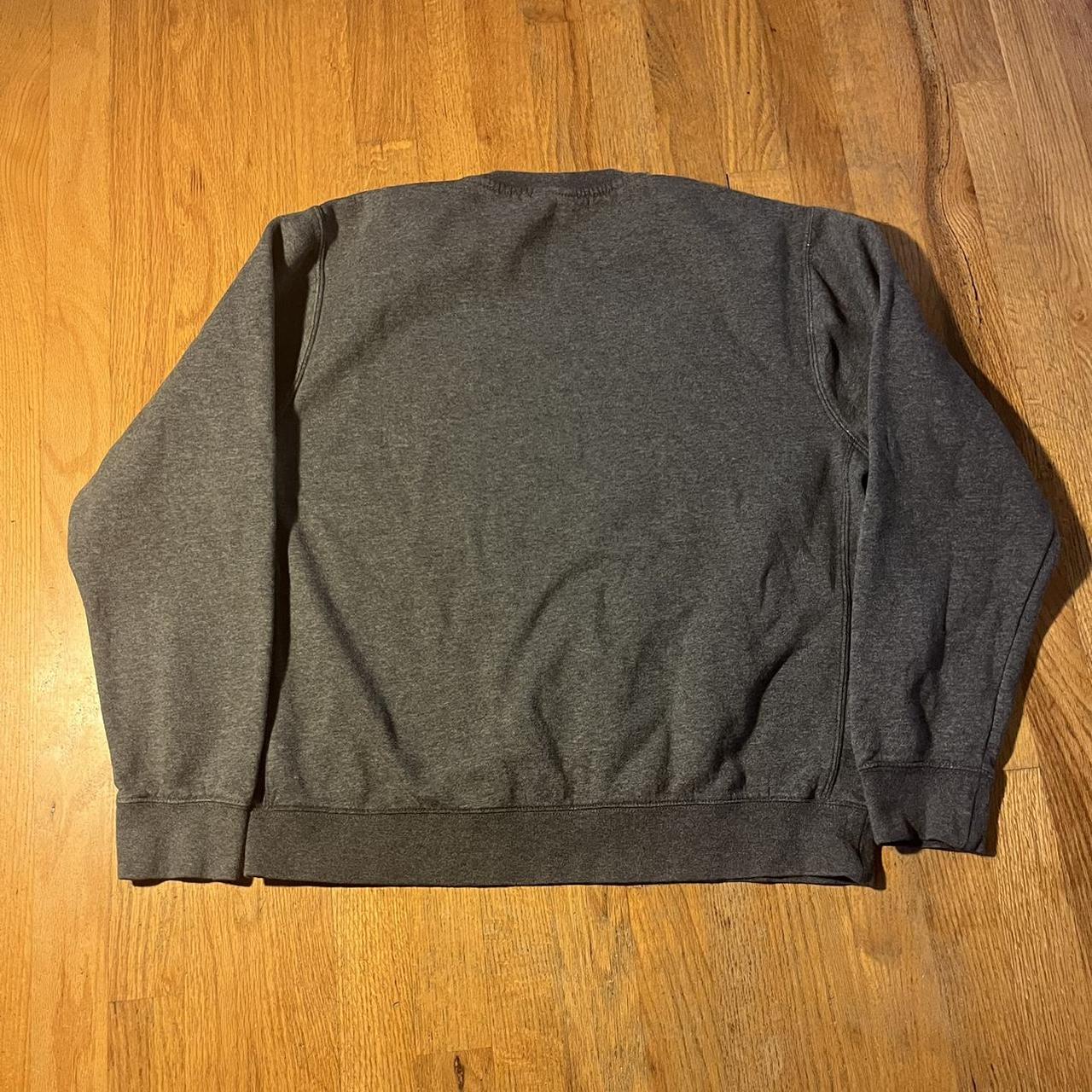 Nike grey crew neck. Perfect conditon besides ripped... - Depop