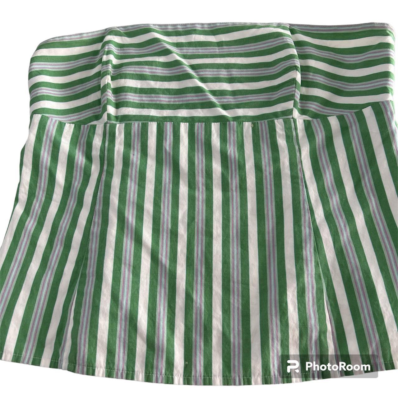 A strapless green top that is a size 6. It fits more... - Depop