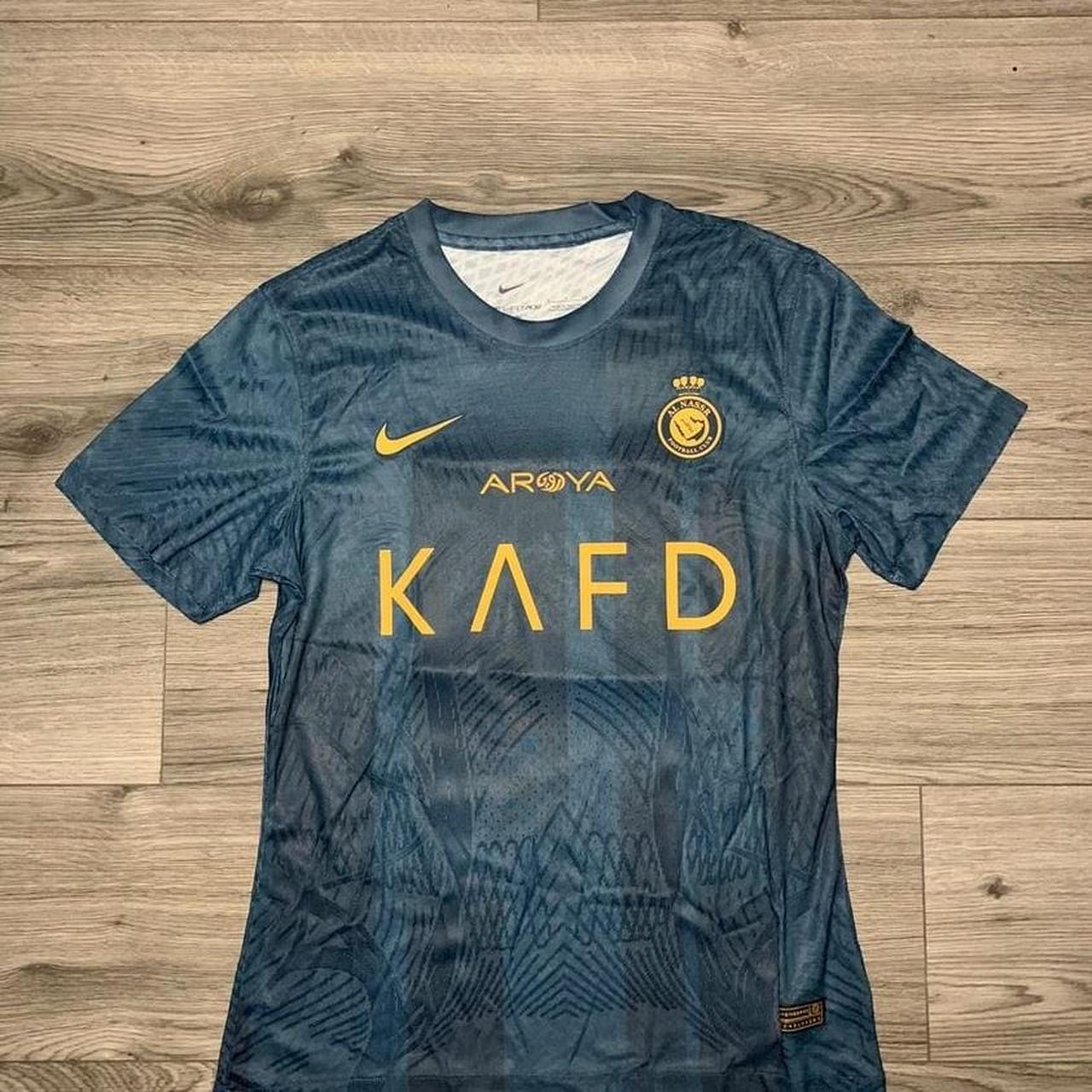 navy blue and gold nike shirt