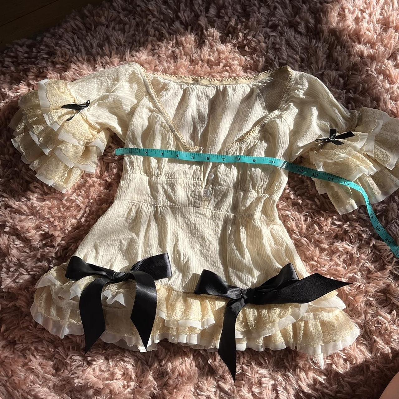 1/1 Cream and black bow top with lace trim Brand is... - Depop