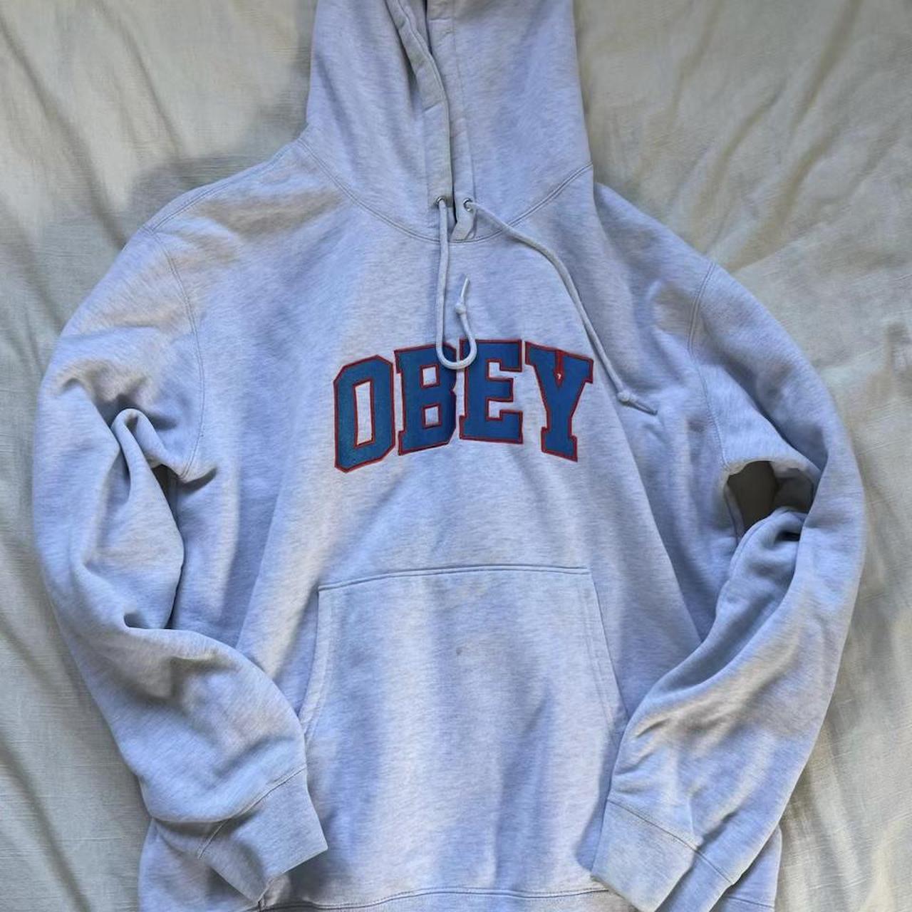 Obey men's grey hoodie with blue and red lined... - Depop