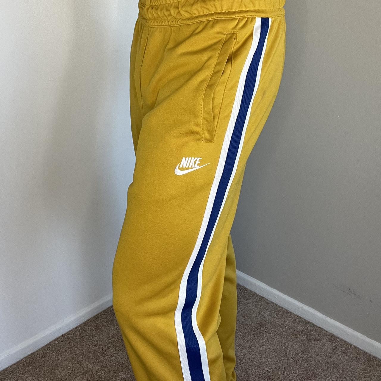 nike gold track pants