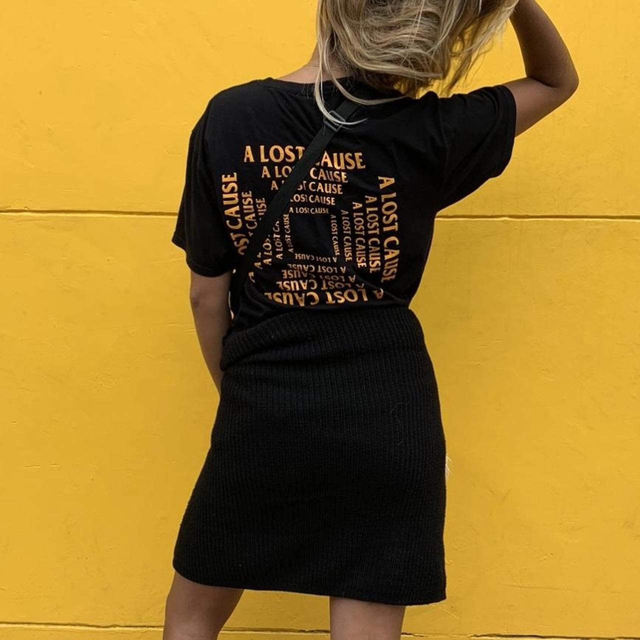 Black shirt with yellow writing best sale