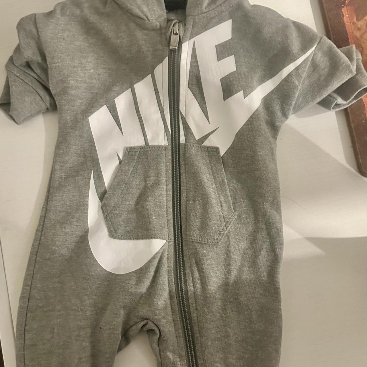 Grey and white Nike baby onesie