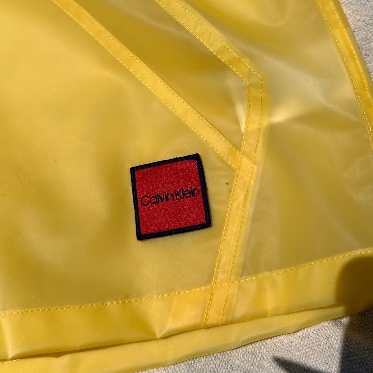 Calvin Klein Yellow rain jacket transparent with... Depop