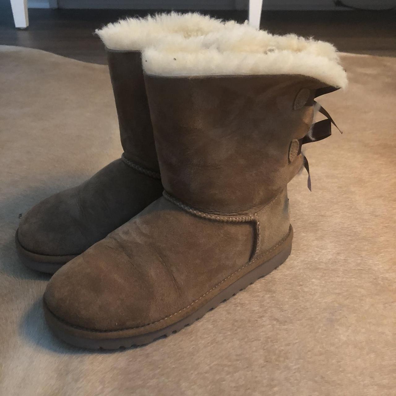 Adorable, croquette beige uggs. With two brown bows... - Depop