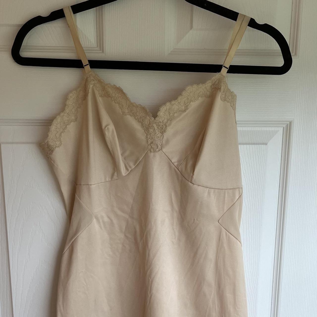 Vintage nude slip. Nylon type fabric and constructed... - Depop