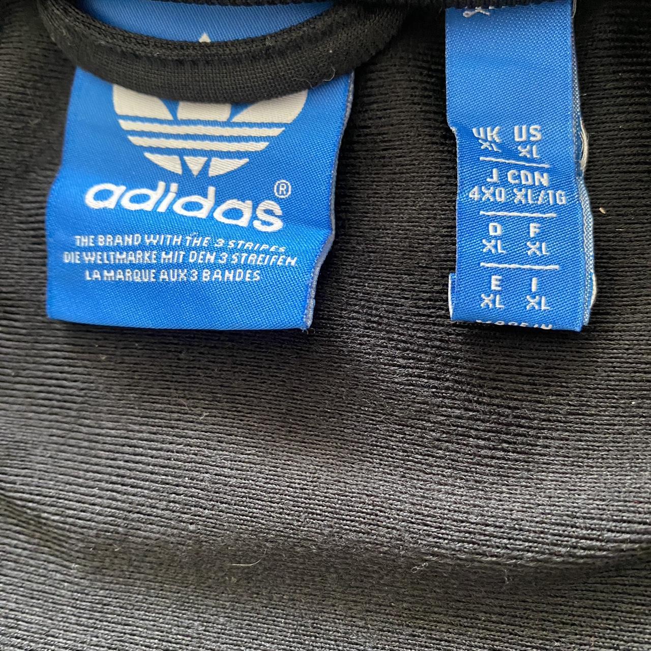 Adidas originals black track top with white stripes... Depop
