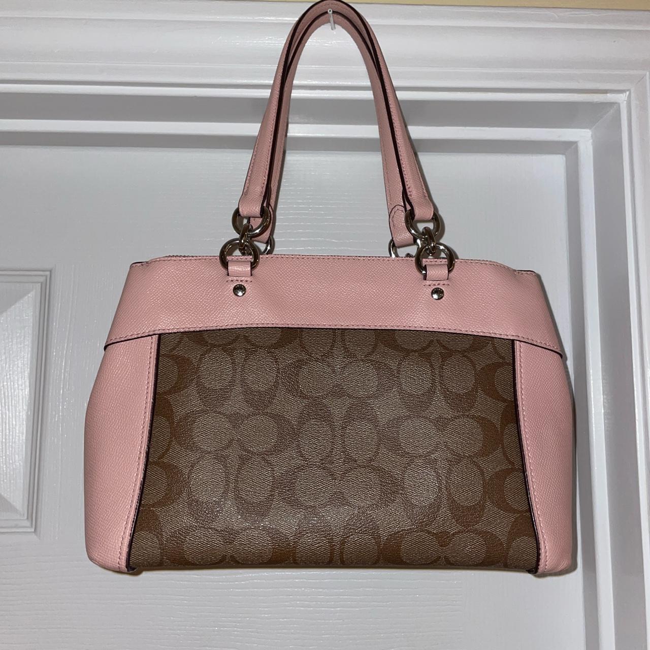 Dark brown coach handbag. Bag has pink strap & pink