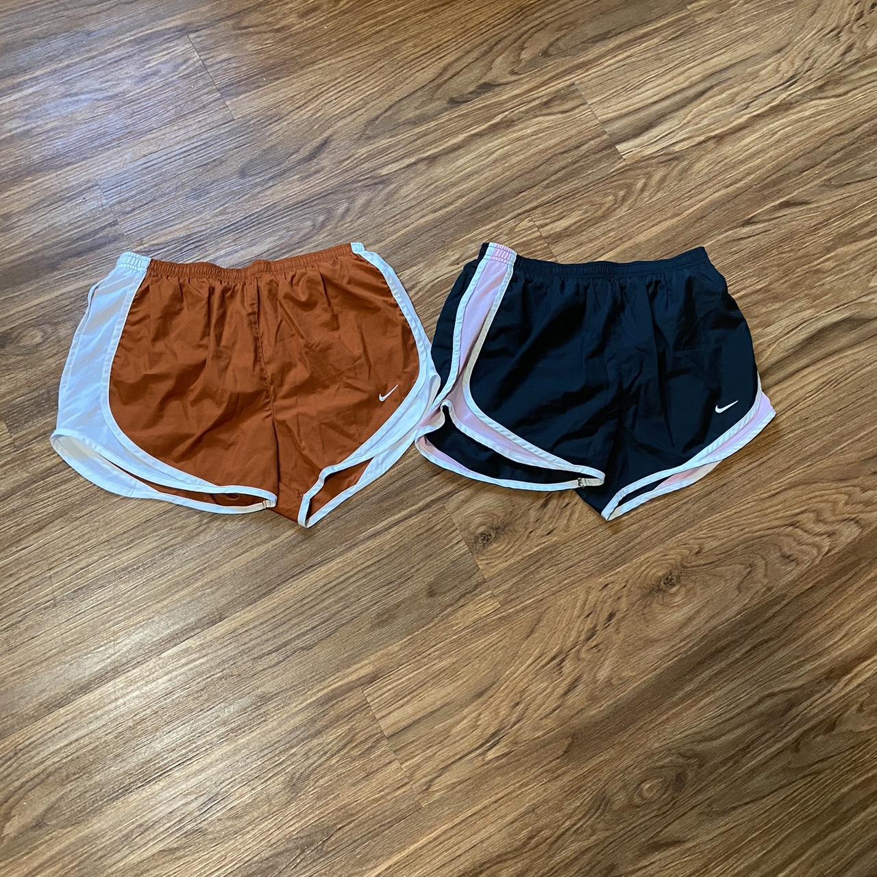 orange white and black nike shorts