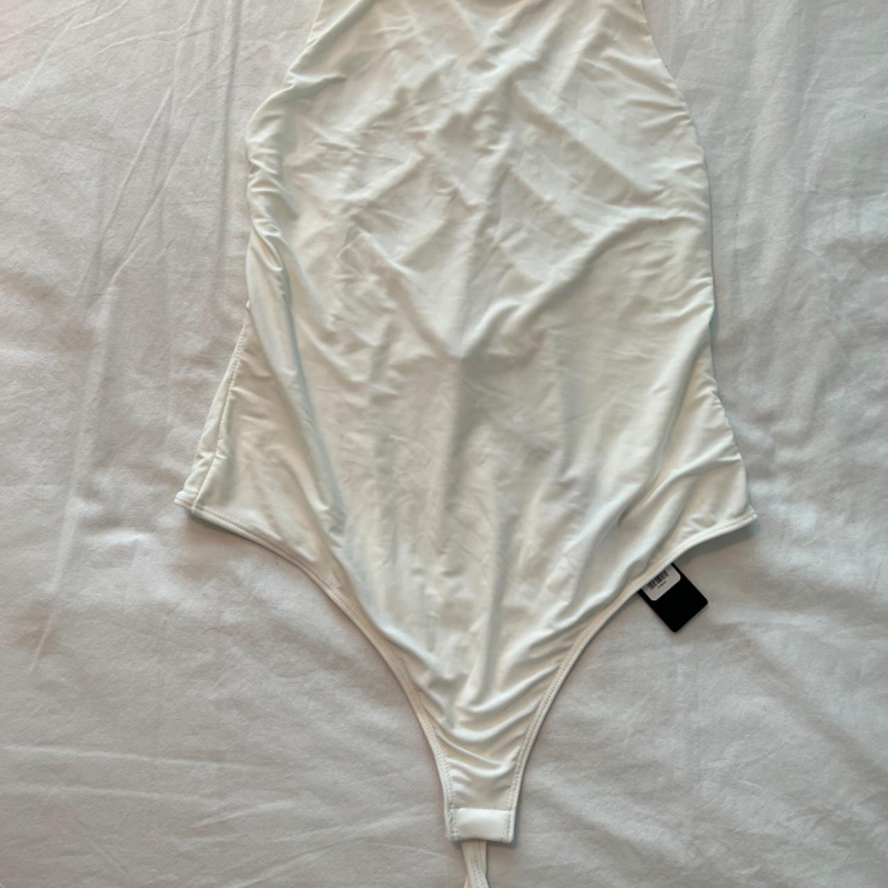 Large, white, and criss cross bodysuit. Perfect top... - Depop