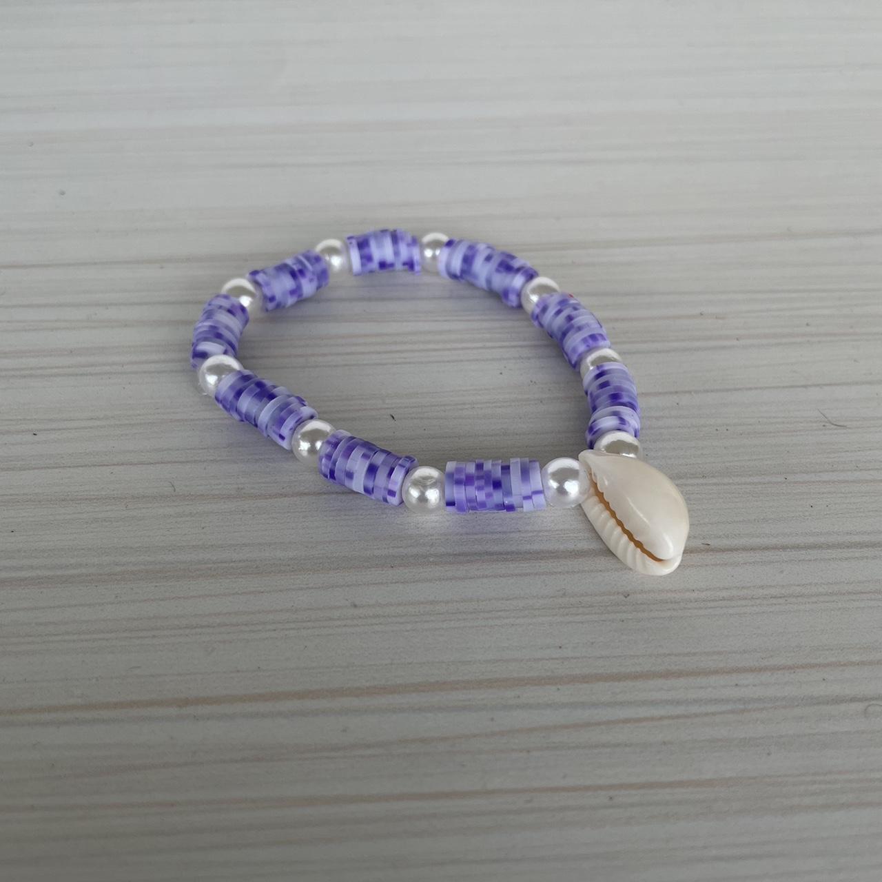clay beads bracelets. one is purple with a flower - Depop