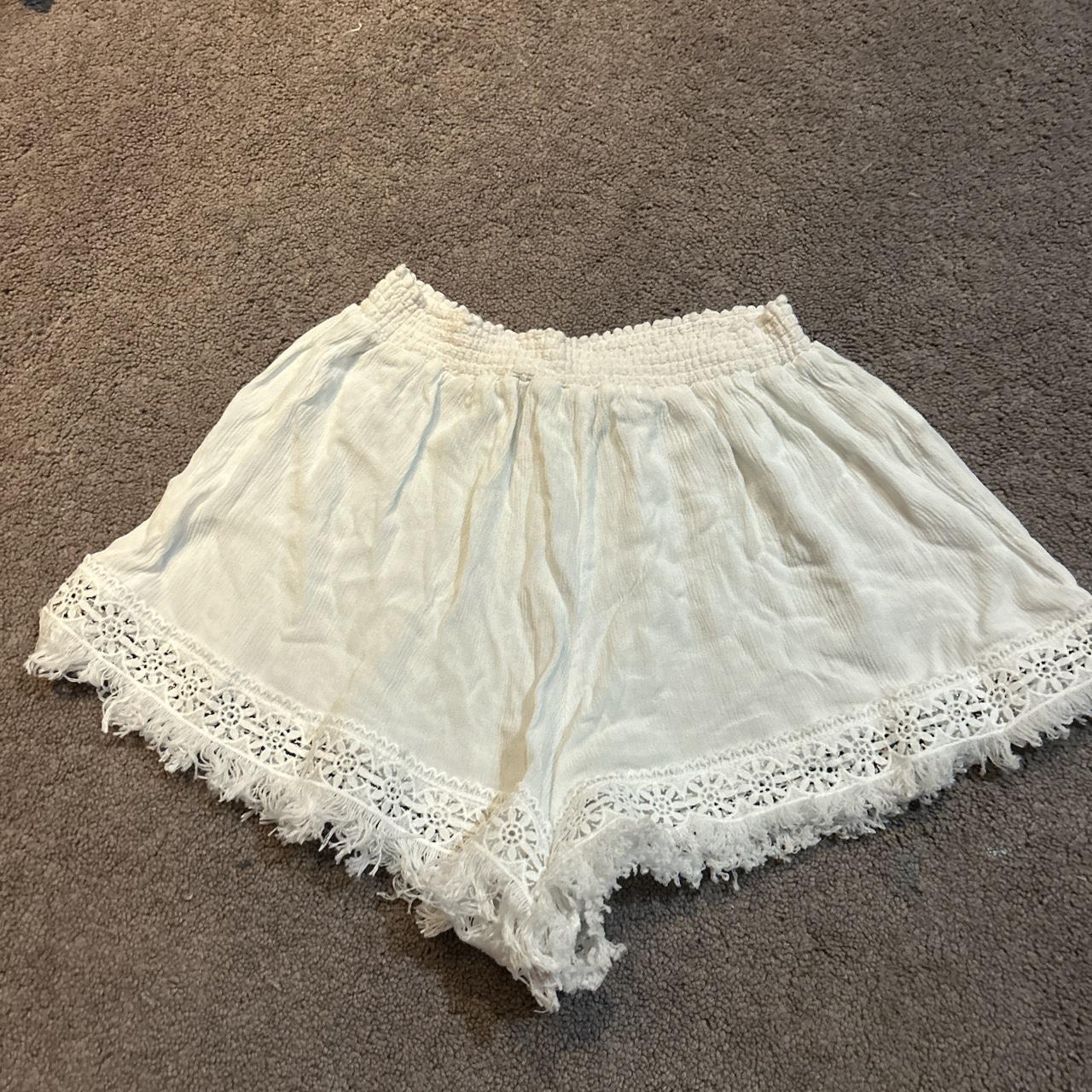 White beach shorts with designs at the bottom, new... Depop