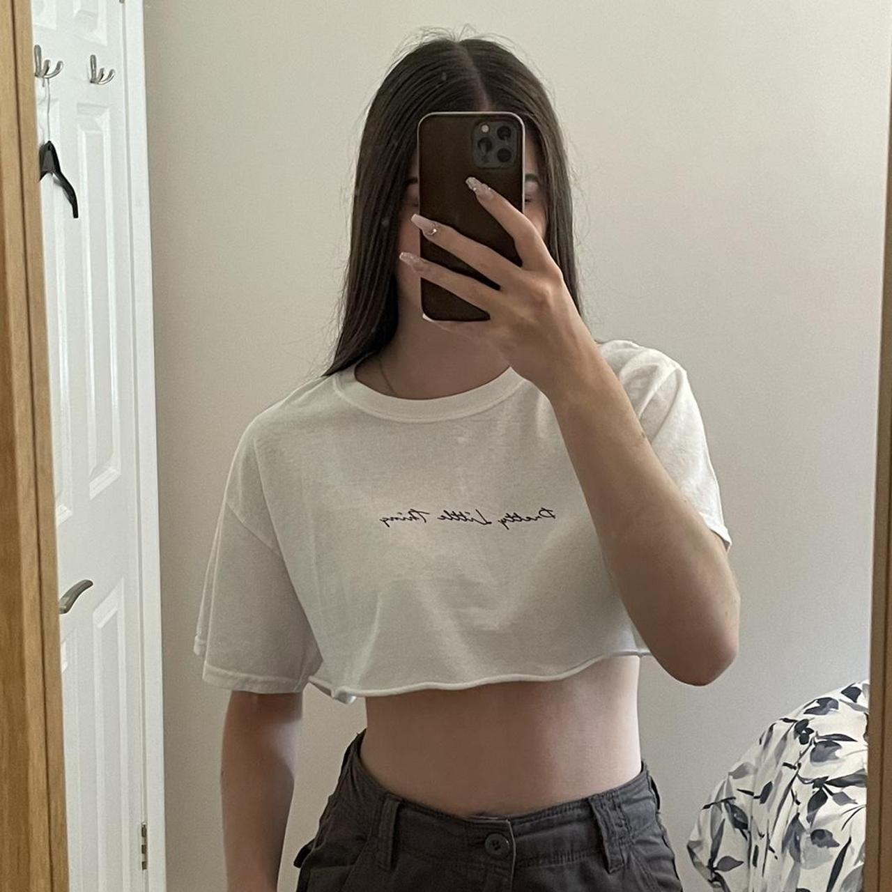 Small white crop t-shirt with ‘pretty little thing’... - Depop