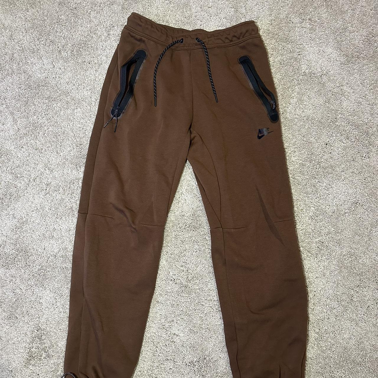 Small brown nike tech pants with zipper pockets.... - Depop
