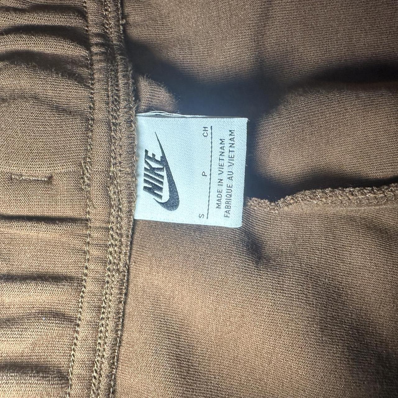 Small brown nike tech pants with zipper pockets.... - Depop