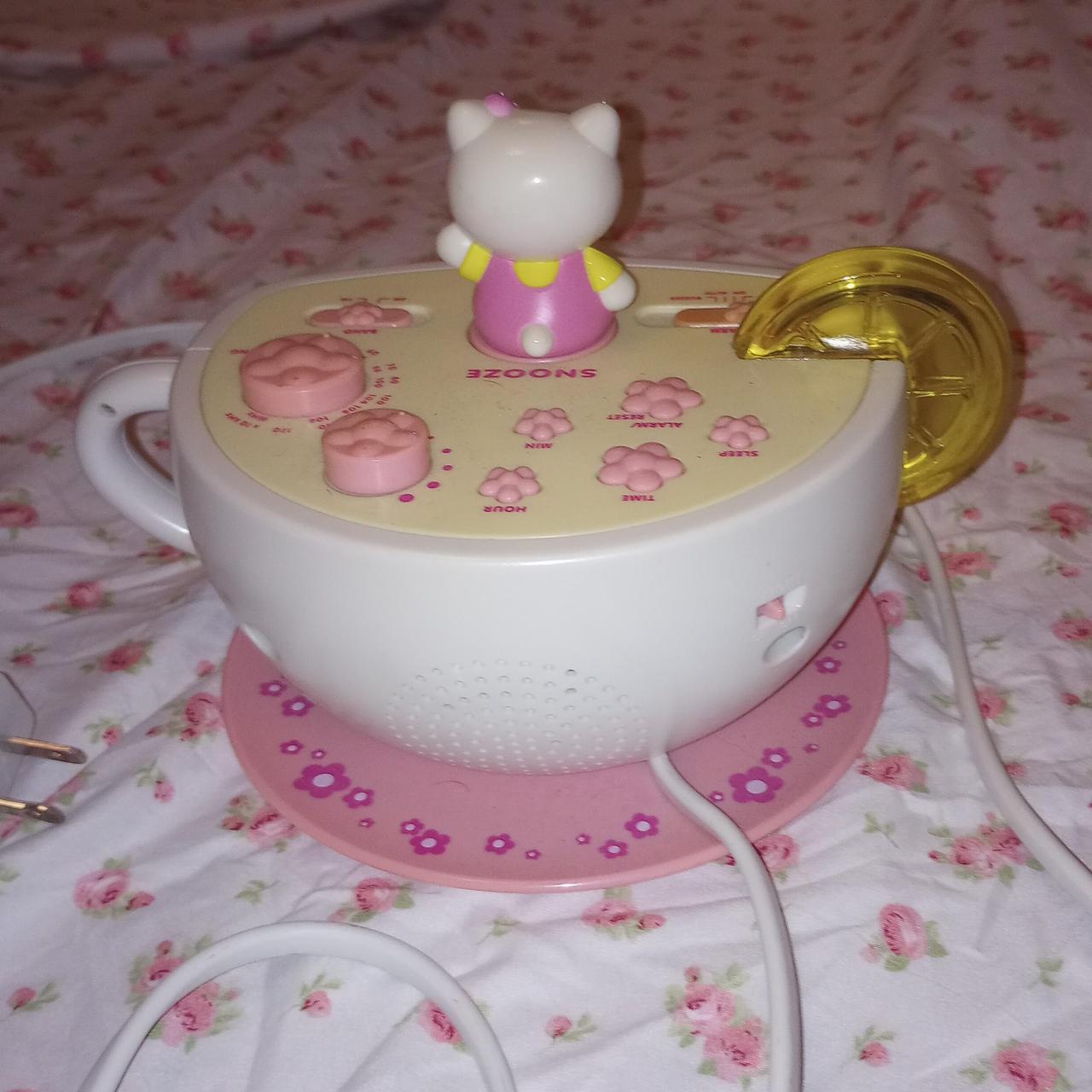 Hello kitty teacup clock and alarm clock.really good... Depop