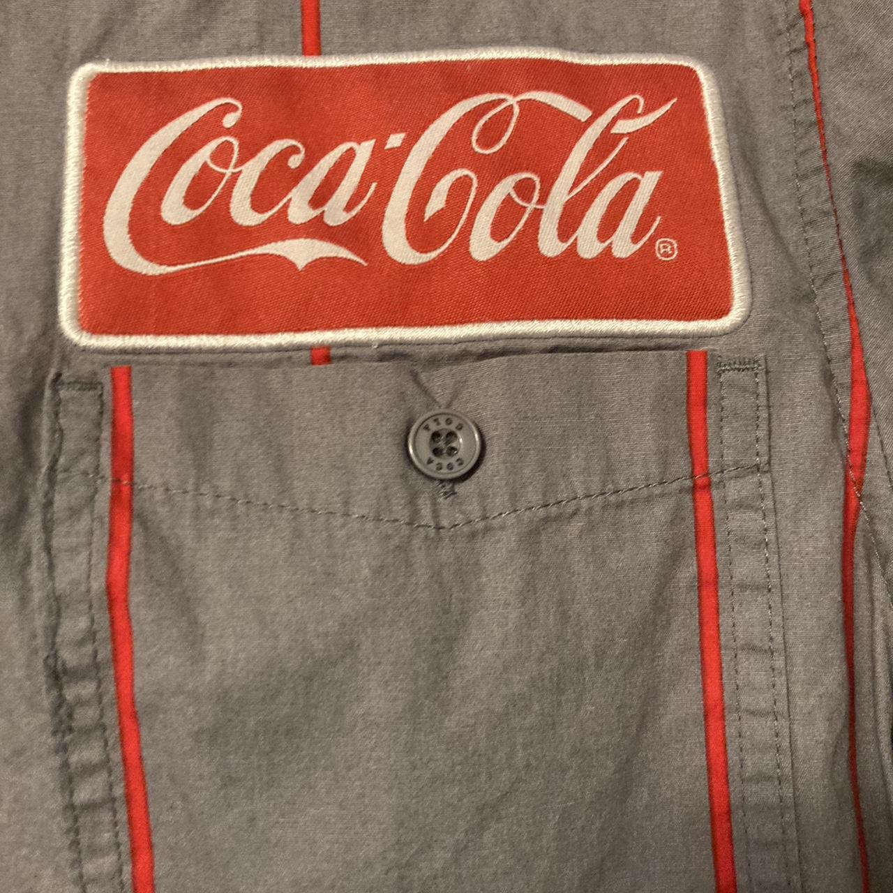 Coke Dress shirt only flaw is button on bottom... - Depop