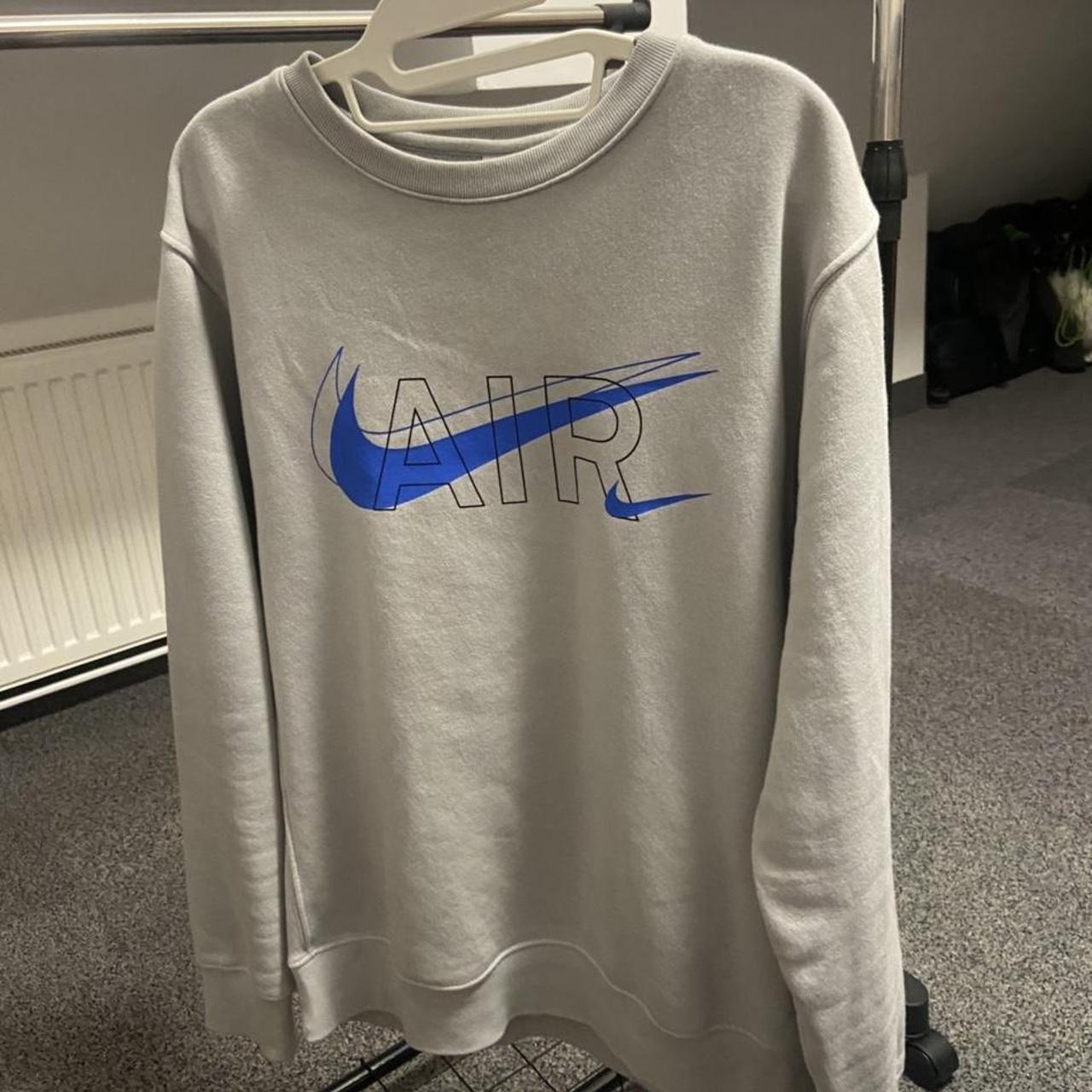 Light grey Nike jumper with a blue swoosh. Size small - Depop