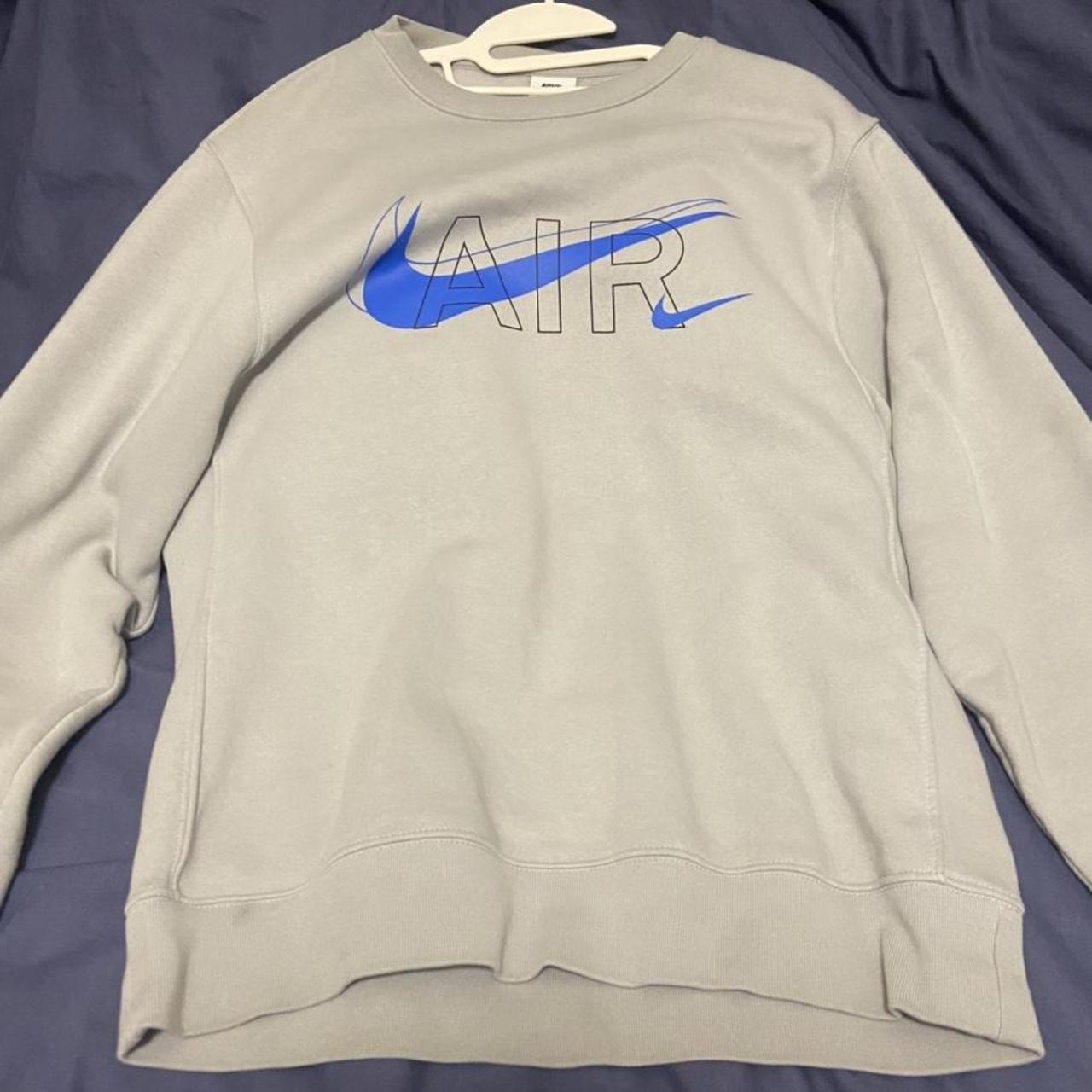 Light grey Nike jumper with a blue swoosh. Size small - Depop