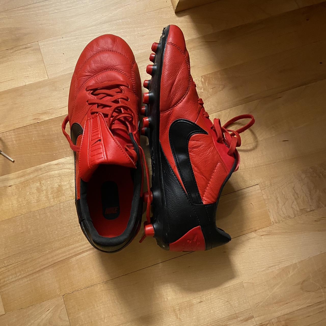 red and black soccer shoes