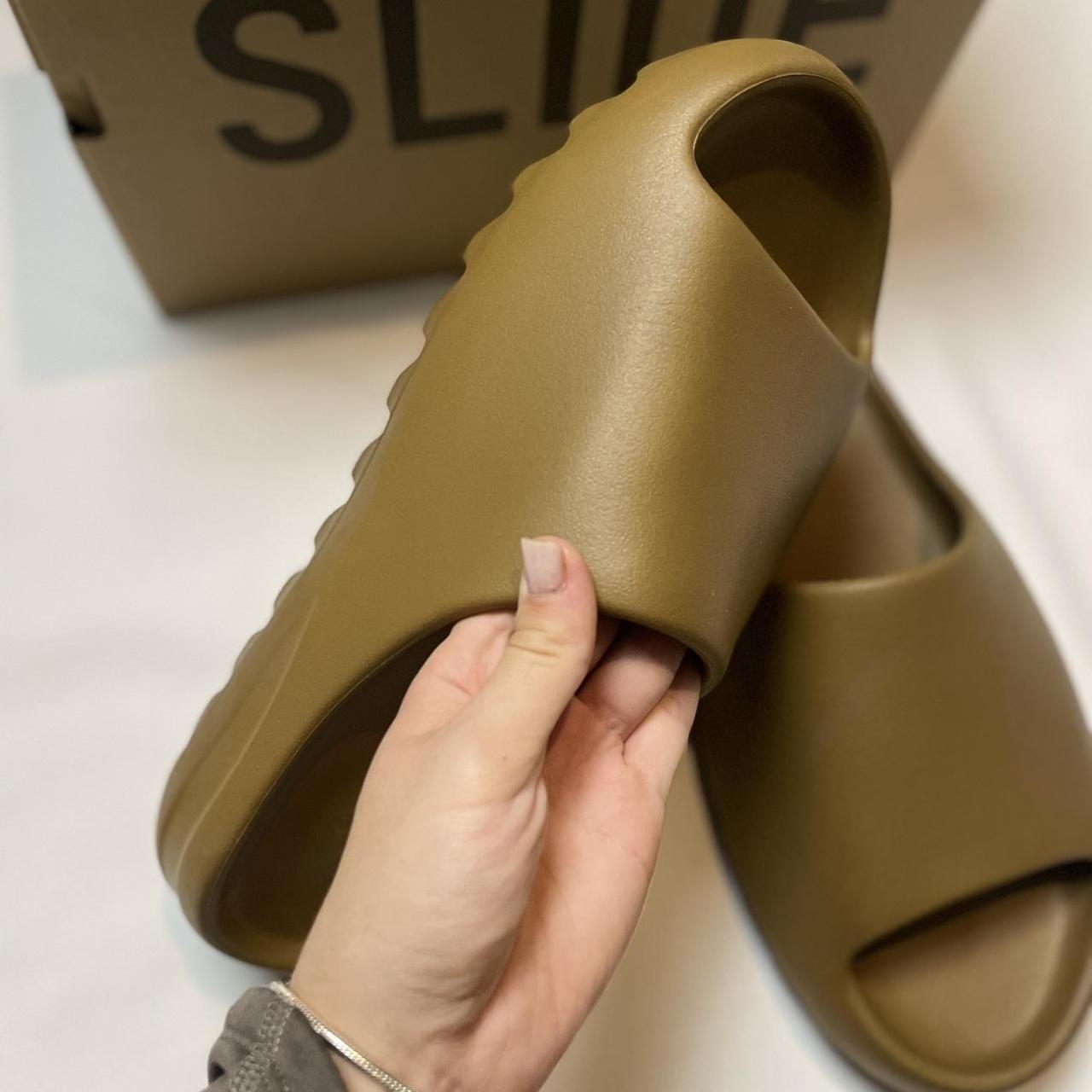 brown yeezy slides on feet