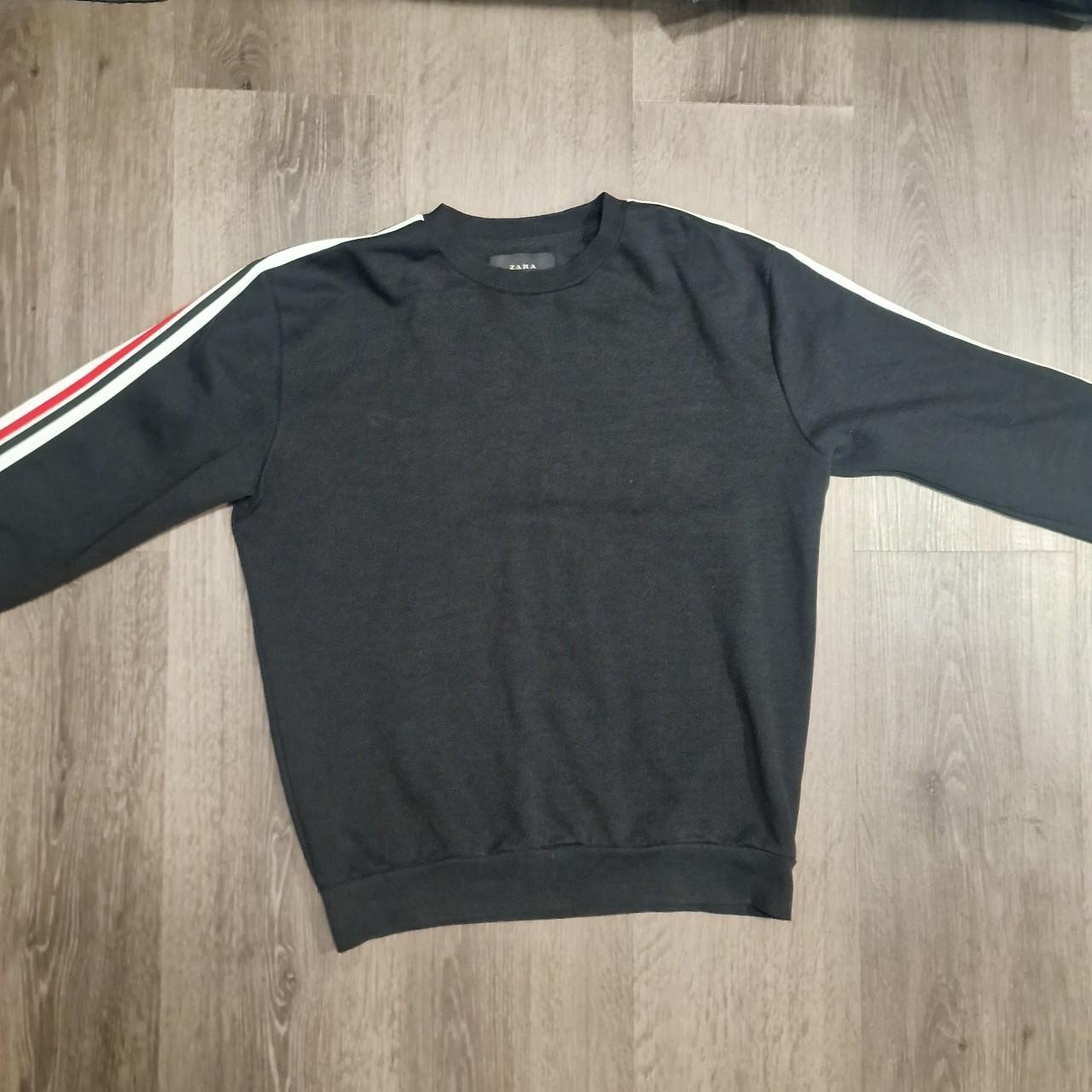 Black jumper with 2025 red stripe down sleeve