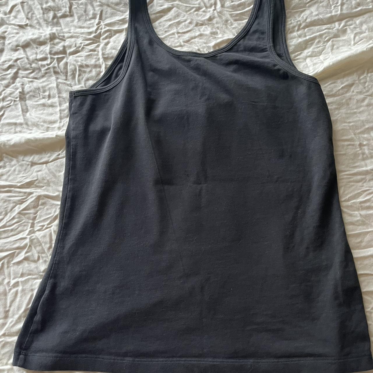 Girl in red Black tank top with a unique graphic... | Depop