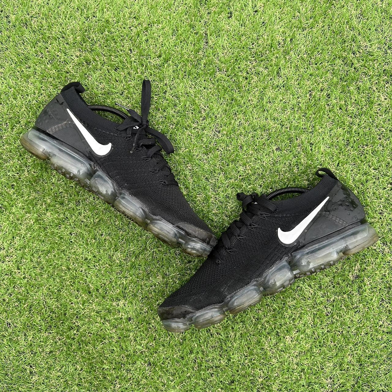 black nike trainers with white tick