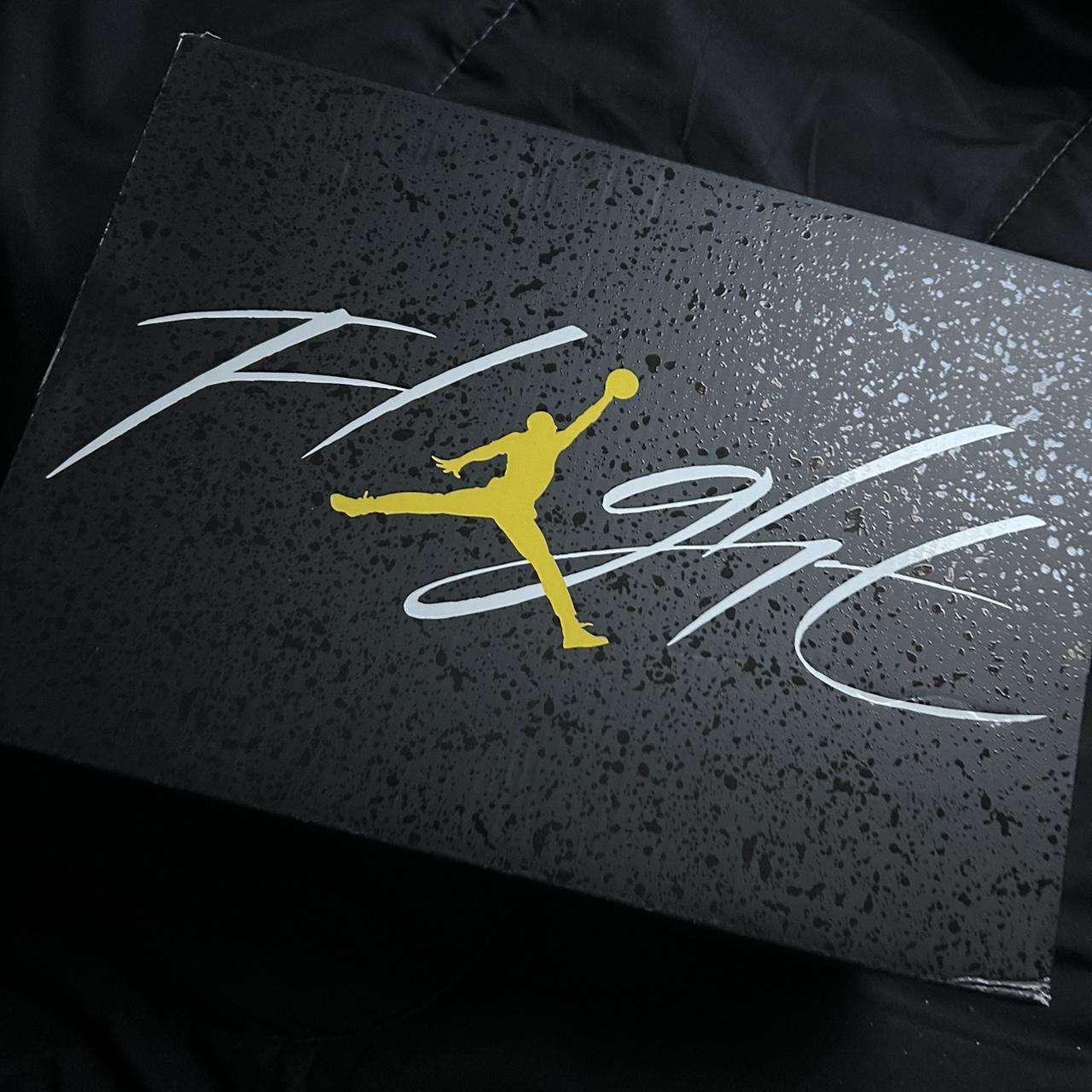 black and yellow jordan 4's