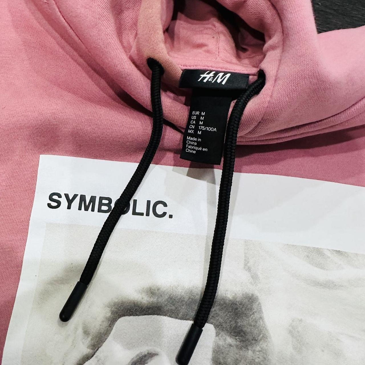 Pink H M hoodie symbolic