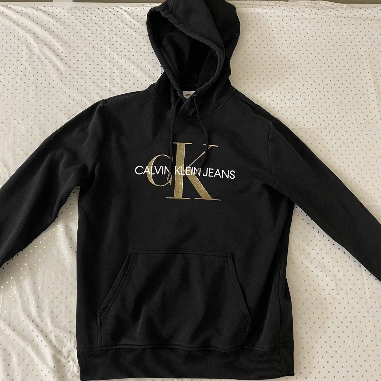 Small Black and Gold Calvin Klein Hoodie great. Depop