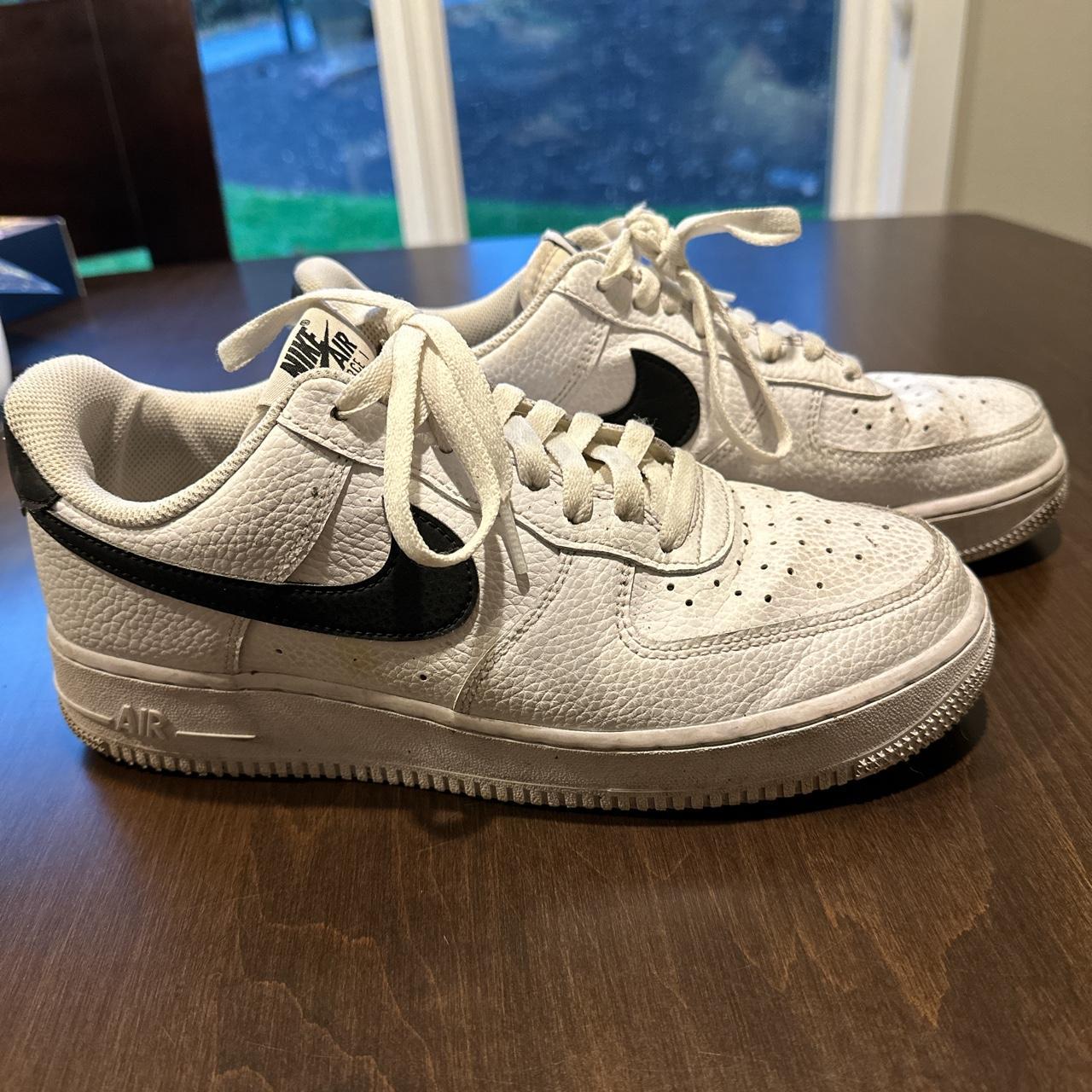 Nike Air Force 1 with a black swoosh and part of the... - Depop