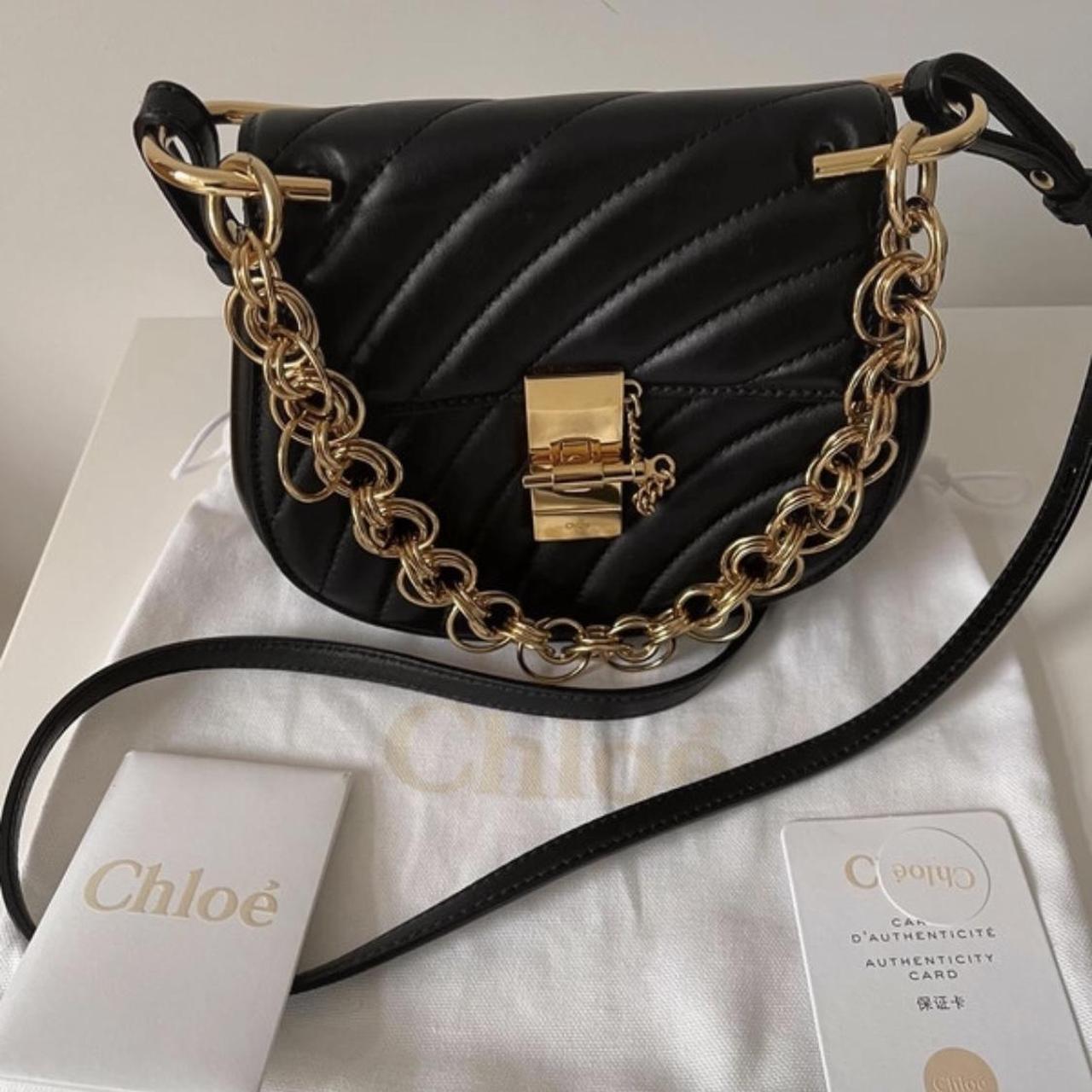 Modern black and gold purse with adjustable chain