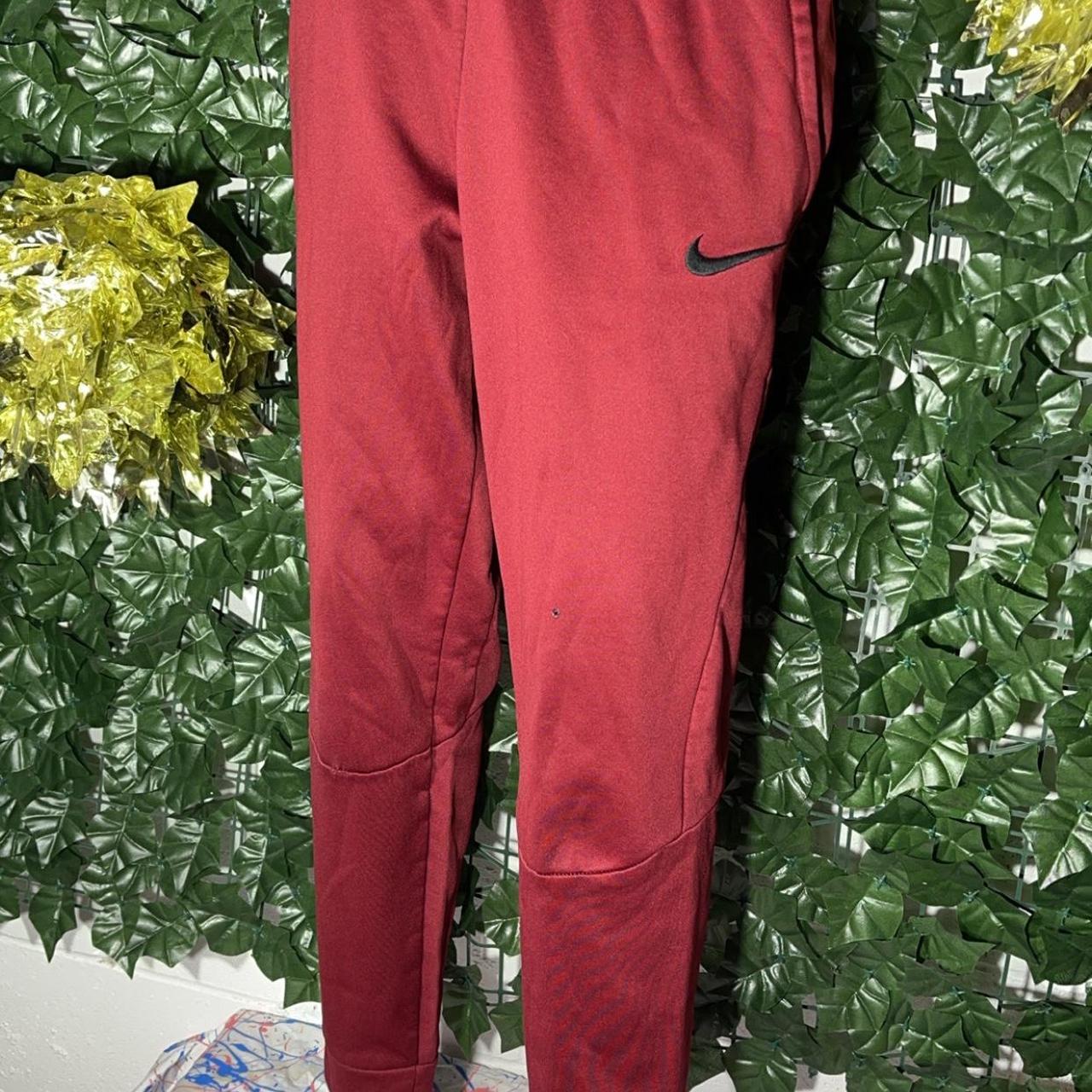 Burgundy Nike sweatpants Small burn hole but in Depop