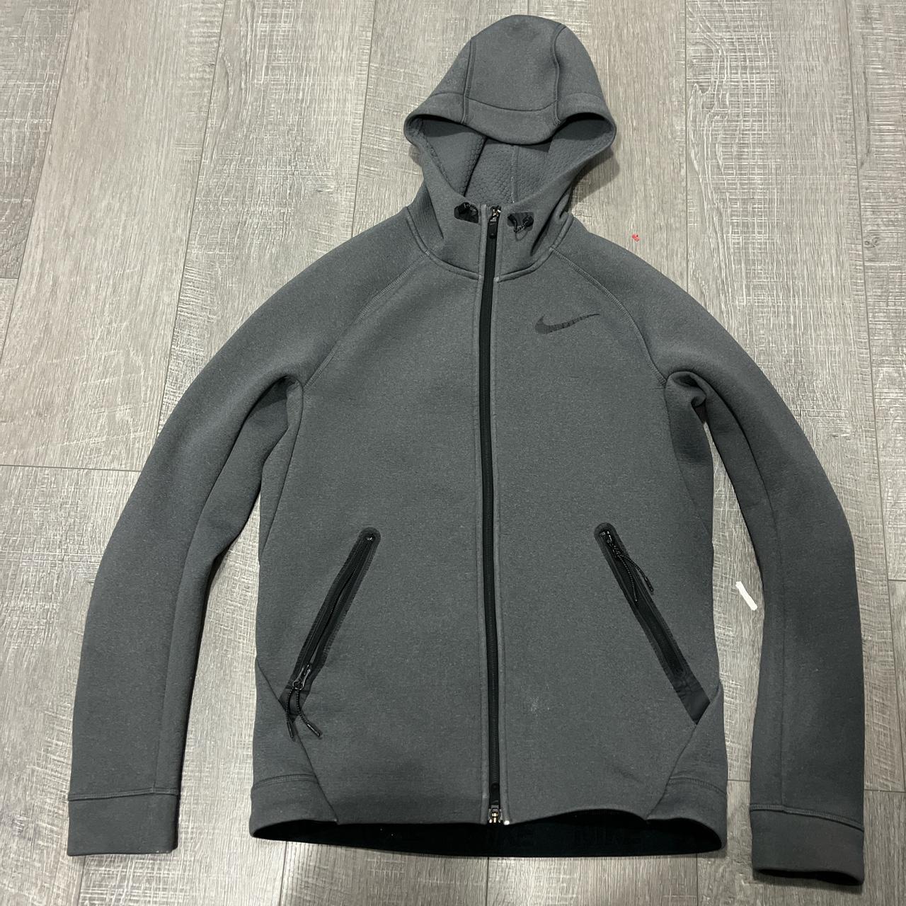 medium gray nike tech jacket, worn and little tear... Depop