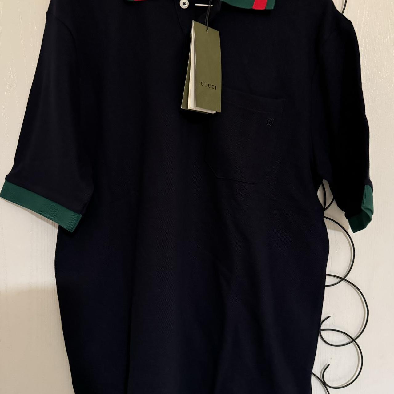 black gucci polo with red and green collar