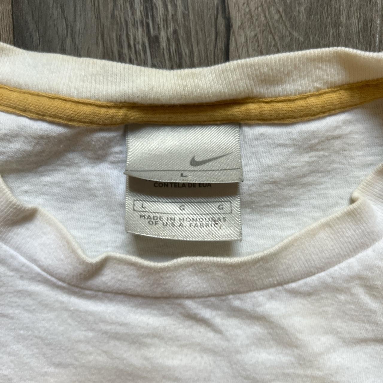 tan and white nike shirt