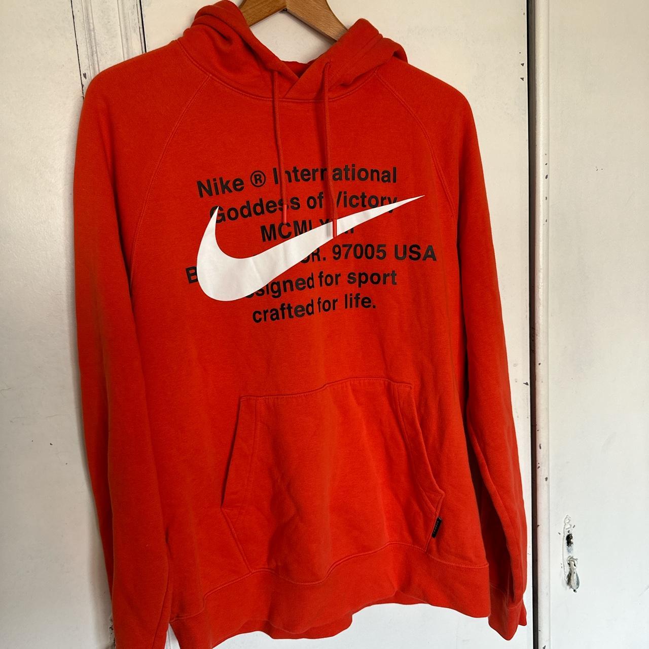 white nike hoodie with orange logo