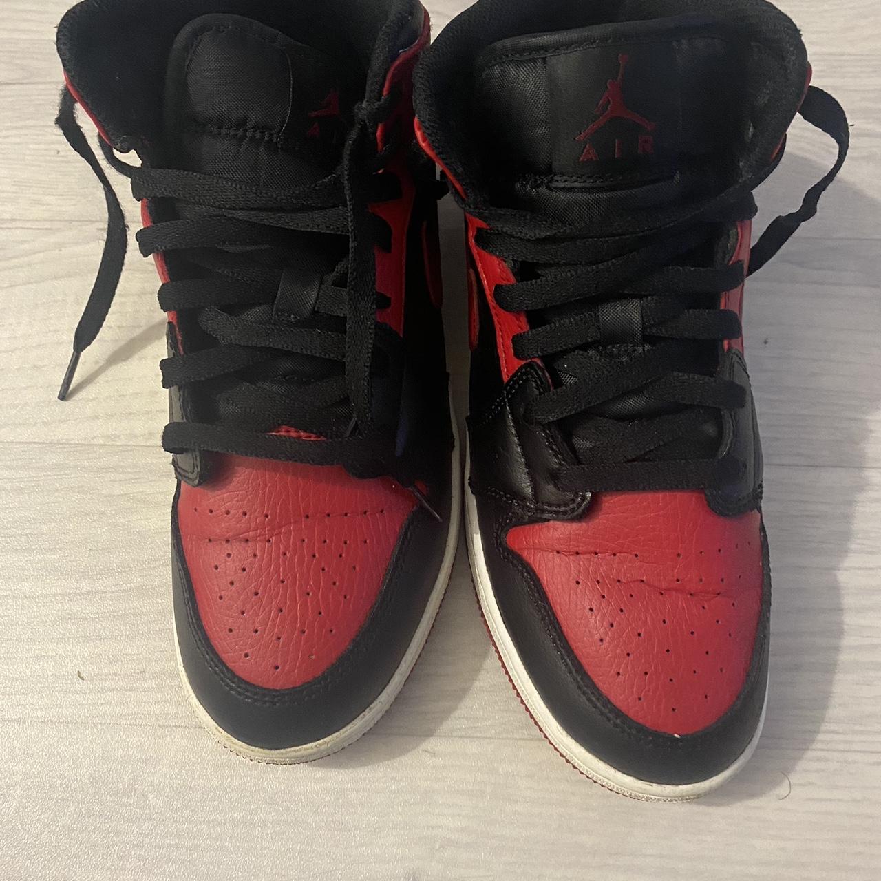 half black half red jordan ones