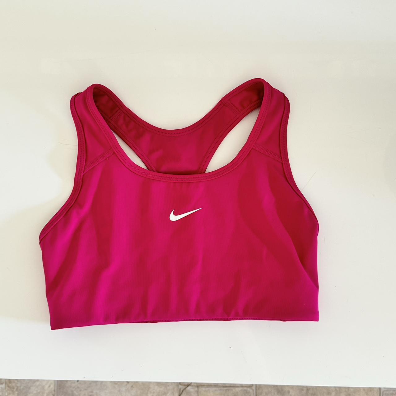 Hot Pink Nike sports bra. Size small but is on the - Depop