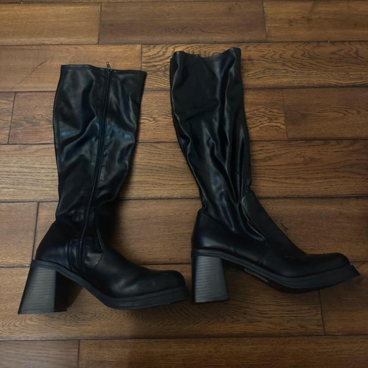 Black knee high boots with a 3 inch heel